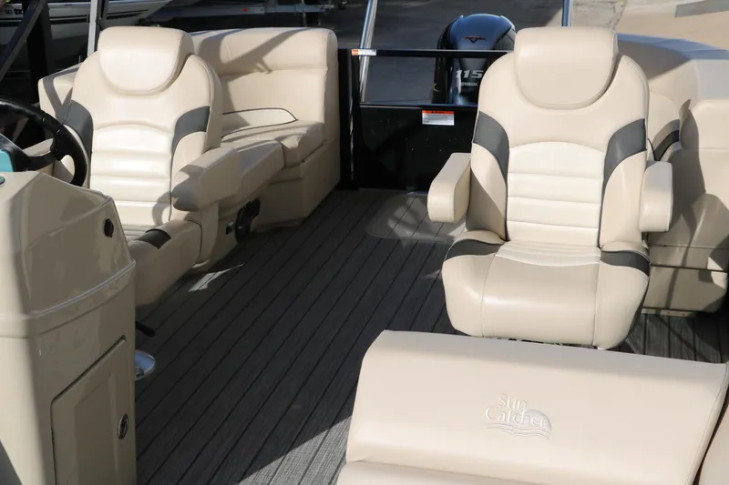 Slide: The Image of 2024 SunCatcher Select 320 RC boat interior with beige seating and steering console. - 23