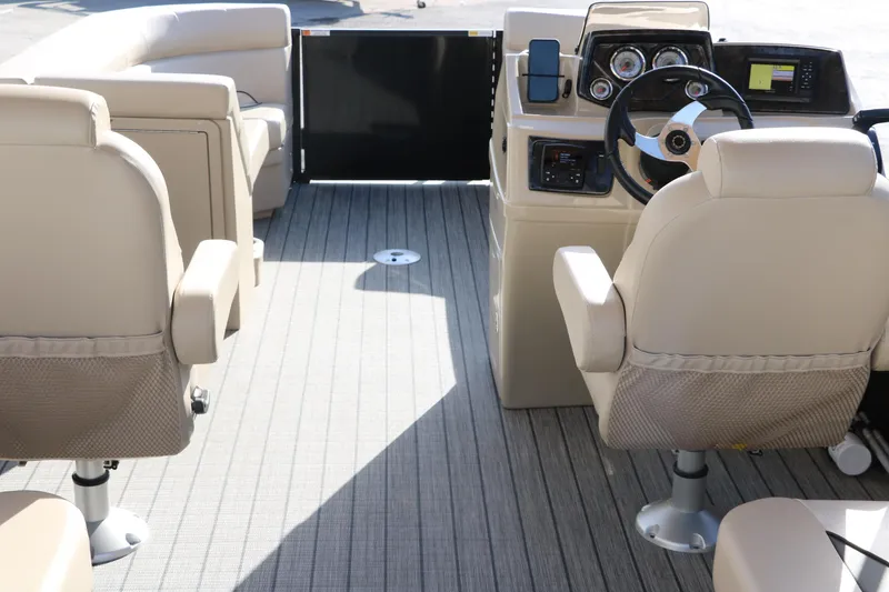 Slide: The Image of 2024 SunCatcher Select 320 RC boat interior with beige seating and modern dashboard. - 26