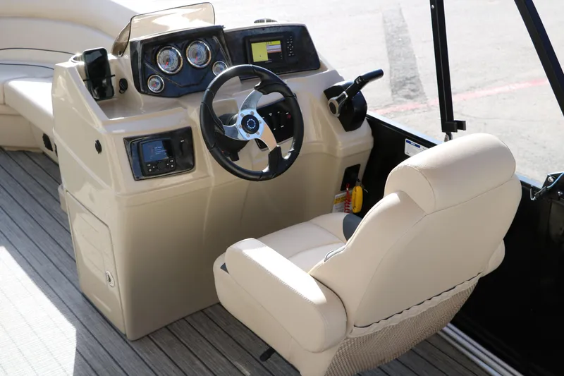 Slide: The Image of 2024 SunCatcher Select 320 RC boat helm with steering wheel and control panel. - 28
