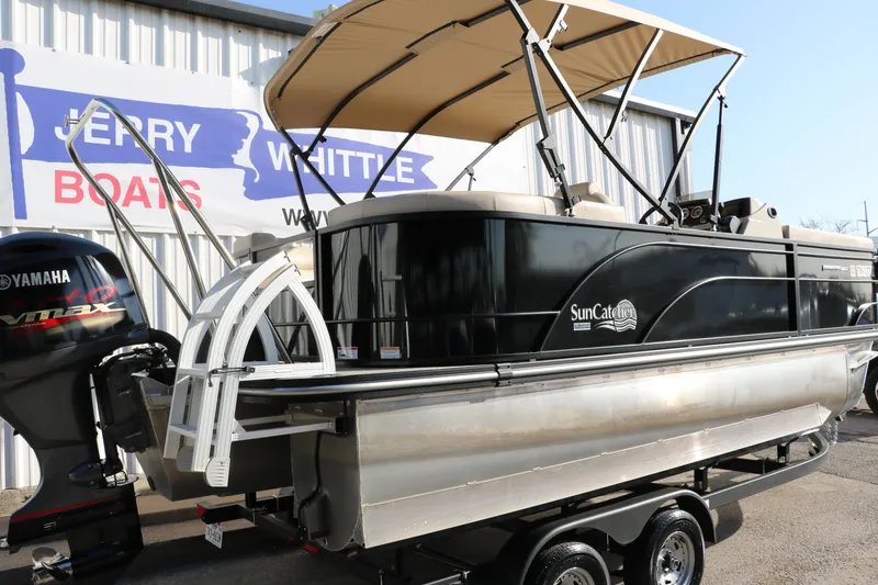 Slide: The Image of 2024 SunCatcher Select 320 RC pontoon boat on trailer, with Yamaha engine, at dealership. - 3