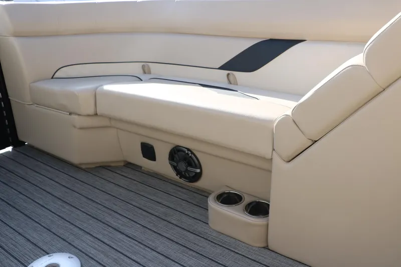 Slide: The Image of 2024 SunCatcher Select 320 RC boat interior with beige seating and cup holders. - 32