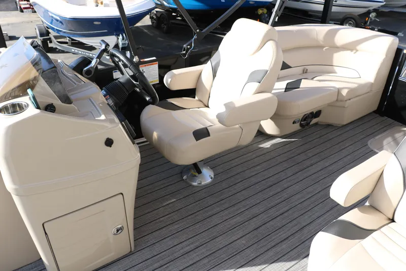 Slide: The Image of 2024 SunCatcher Select 320 RC boat interior with beige seating and steering console. - 33