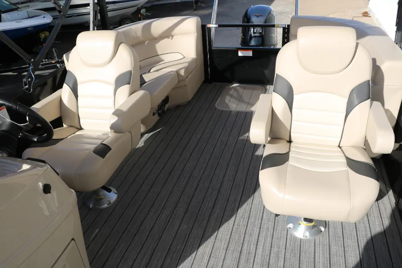 Slide: The Image of 2024 SunCatcher Select 320 RC boat interior with beige seating and modern design. - 34
