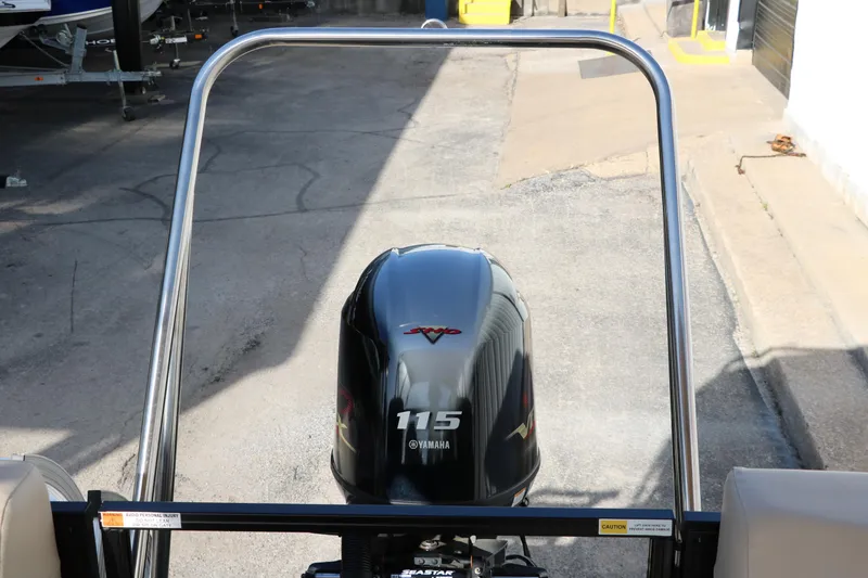 Slide: The Image of 2024 SunCatcher Select 320 RC with Yamaha 115 engine, rear view in a parking area. - 35