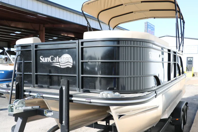 Slide: The Image of 2024 SunCatcher Select 320 RC pontoon boat on trailer, outdoor display. - 7