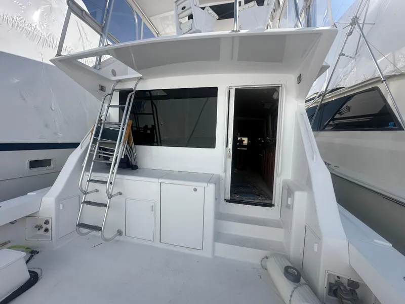 Slide: The Image of 1998 Viking 53 Convertible yacht with ladder and open cabin door. - 1