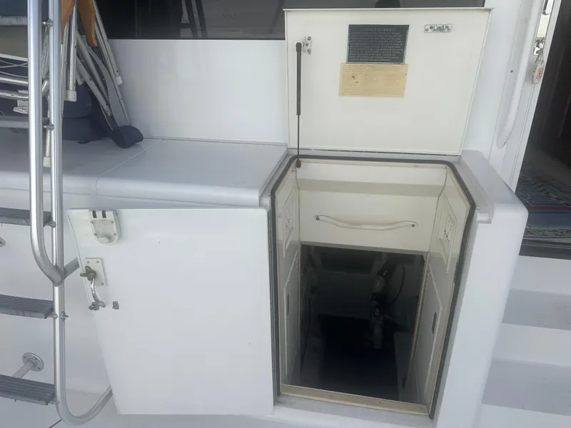 Slide: The Image of 1998 Viking 53 Convertible yacht interior access hatch with storage compartments. - 11