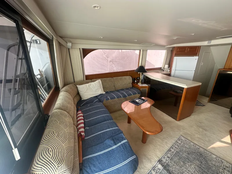 Slide: The Image of Luxurious interior of a 1998 Viking 53 Convertible yacht with cozy seating and modern amenities. - 21
