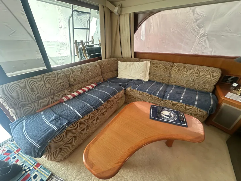 Slide: The Image of Cozy interior of 1998 Viking 53 Convertible yacht with L-shaped sofa and wooden table. - 22