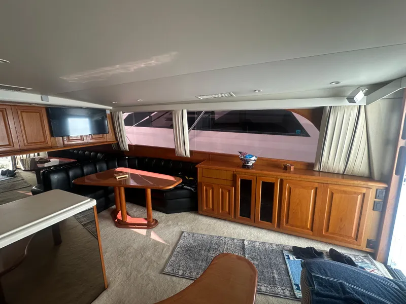 Slide: The Image of Interior of 1998 Viking 53 Convertible yacht with wood cabinetry and seating area. - 23