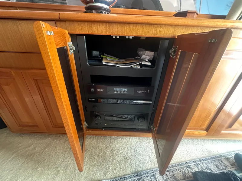 Slide: The Image of Open cabinet on 1998 Viking 53 Convertible yacht showing electronic equipment and storage. - 25