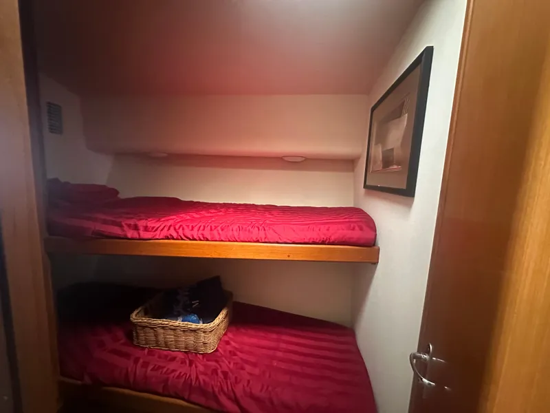 Slide: The Image of Bunk beds with red bedding in 1998 Viking 53 Convertible yacht cabin. - 28