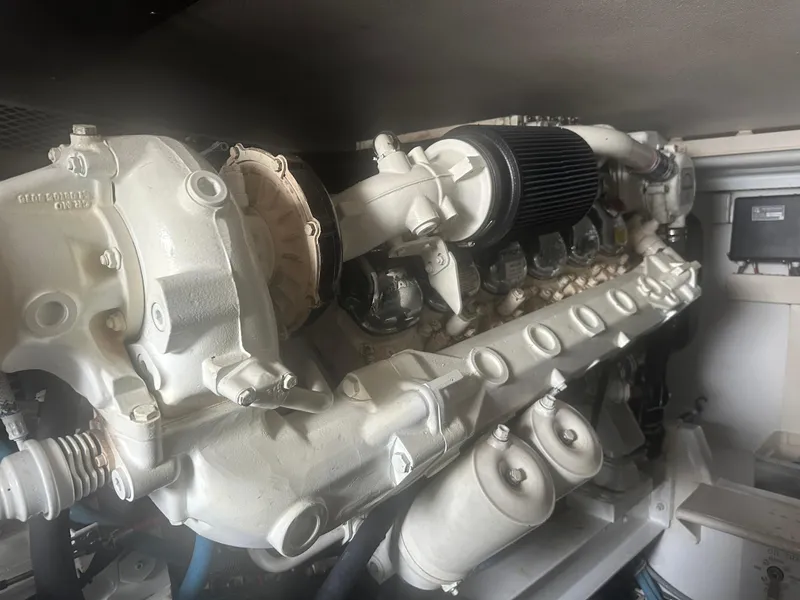 Slide: The Image of Engine of a 1998 Viking 53 Convertible boat, showcasing intricate mechanical components. - 36