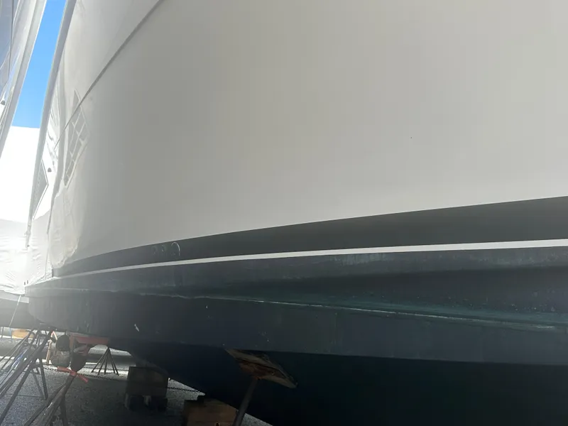 Slide: The Image of 1998 Viking 53 Convertible yacht hull in dry dock, side view. - 8