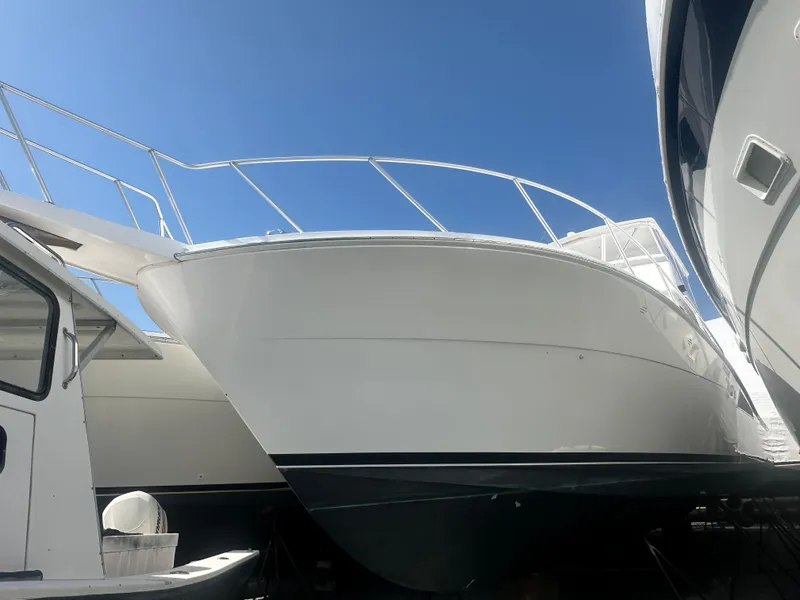 Slide: The Image of 1998 Viking 53 Convertible yacht docked under clear blue sky. - 9