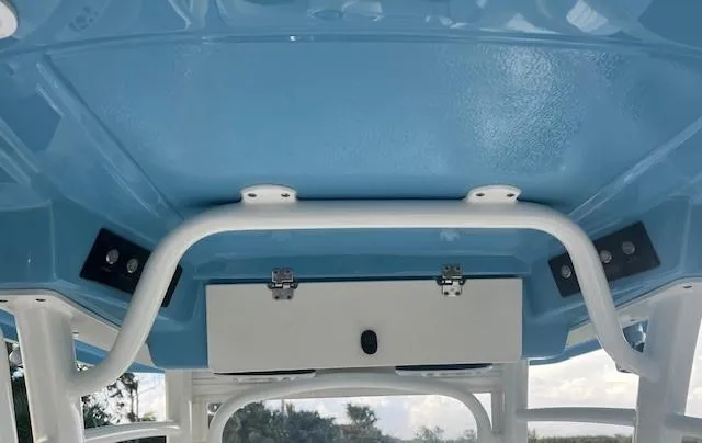 Slide: The Image of 2003 Hydra-Sports Bay Bolt 2300 boat interior, featuring a blue ceiling and storage compartment. - 13