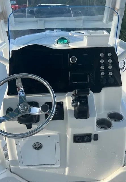 Slide: The Image of 2003 Hydra-Sports Bay Bolt 2300 boat console with steering wheel and control panel. - 14