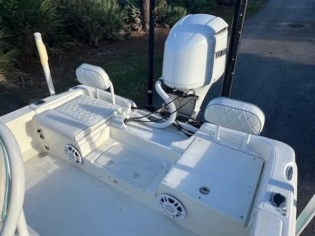Slide: The Image of 2003 Hydra-Sports Bay Bolt 2300 boat interior with Yamaha engine, white seating, and speakers. - 16