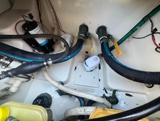 Slide: The Image of 2003 Hydra-Sports Bay Bolt 2300 boat interior with hoses and wiring. - 18