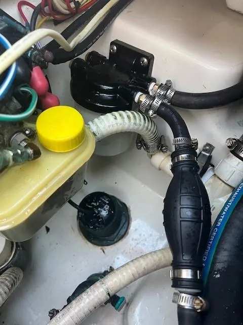 Slide: The Image of 2003 Hydra-Sports Bay Bolt 2300 engine compartment with hoses and fluid reservoir. - 20