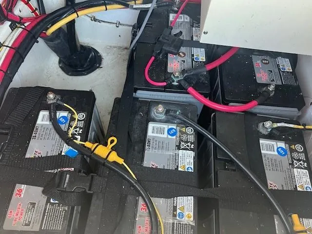 Slide: The Image of Battery compartment of a 2003 Hydra-Sports Bay Bolt 2300 with multiple connected batteries. - 21