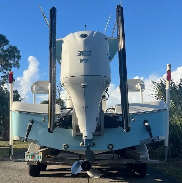 Slide: The Image of 2003 Hydra-Sports Bay Bolt 2300 boat, rear view, with powerful outboard motor, parked outdoors. - 3