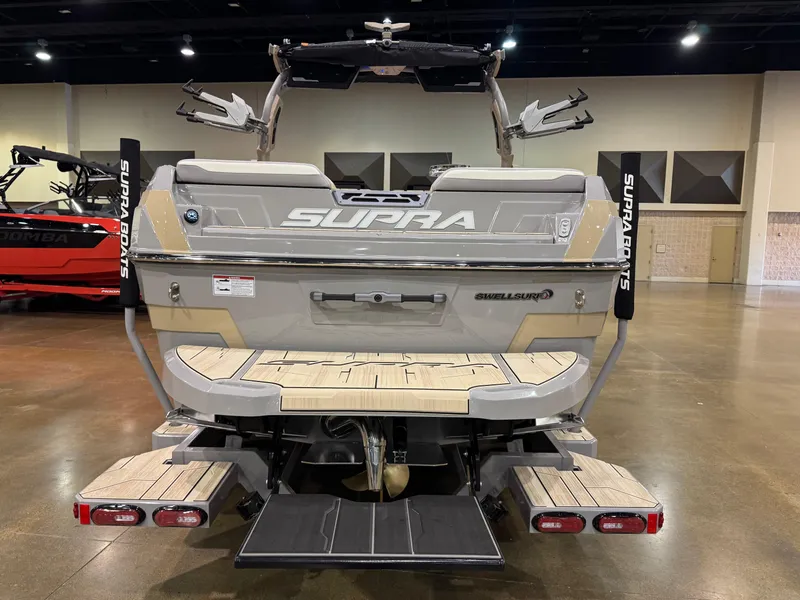 Slide: The Image of 2025 Supra SL boat rear view in showroom, showcasing sleek design and advanced features. - 12