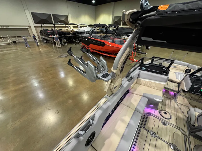 Slide: The Image of 2025 Supra SL boat interior at a showroom with other boats in the background. - 20