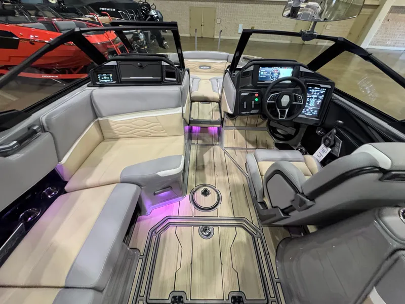 Slide: The Image of 2025 Supra SL boat interior with modern dashboard, plush seating, and ambient lighting. - 22