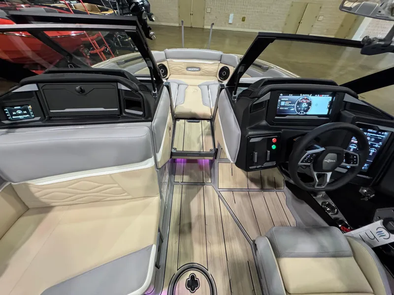 Slide: The Image of 2025 Supra SL boat interior with modern dashboard, plush seating, and sleek design. - 23