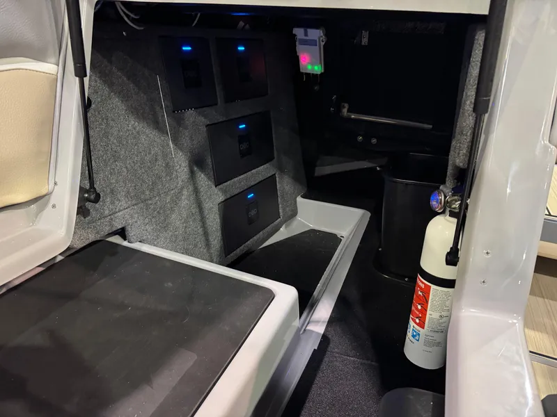 Slide: The Image of Interior of 2025 Supra SL boat with storage compartments and fire extinguisher. - 25