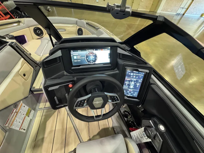 Slide: The Image of 2025 Supra SL boat dashboard with advanced digital displays and modern steering wheel. - 26