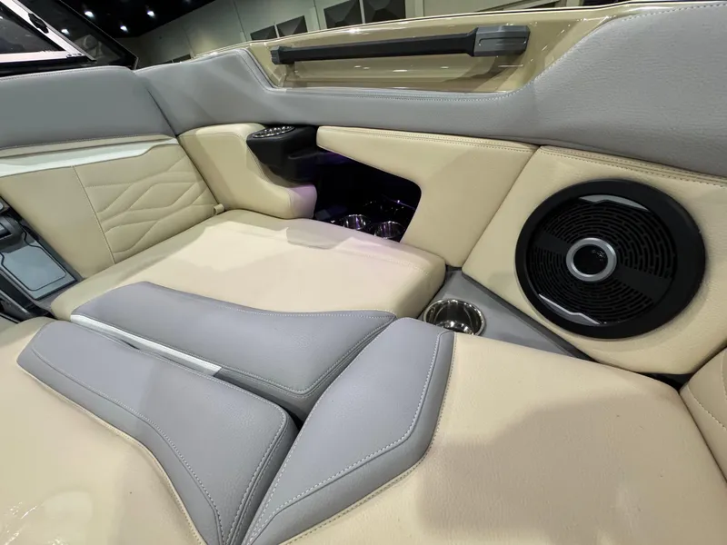 Slide: The Image of 2025 Supra SL interior with beige and gray leather seats, speaker, and cup holders. - 41