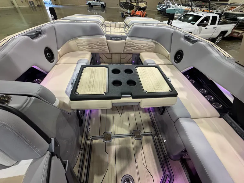 Slide: The Image of 2025 Supra SL boat interior with luxurious seating and a central table, showcased indoors. - 49