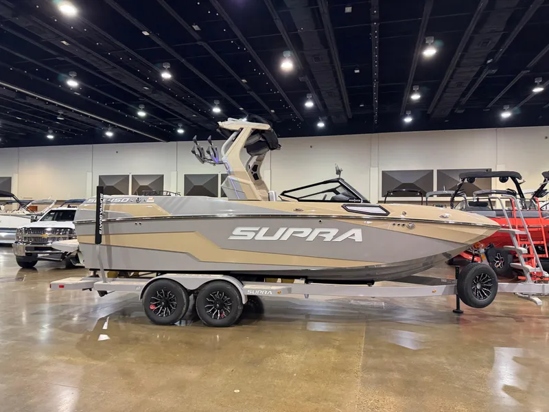 Slide: The Image of 2025 Supra SL boat on display indoors, featuring sleek design and modern features. - 6