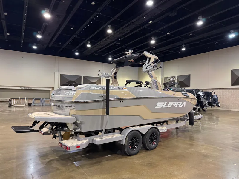 Slide: The Image of 2025 Supra SL boat on trailer in indoor showroom setting. - 7