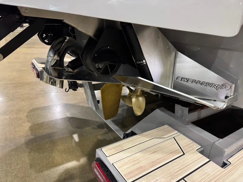 Slide: The Image of 2025 Supra SL boat propeller and swim platform detail in showroom setting. - 9