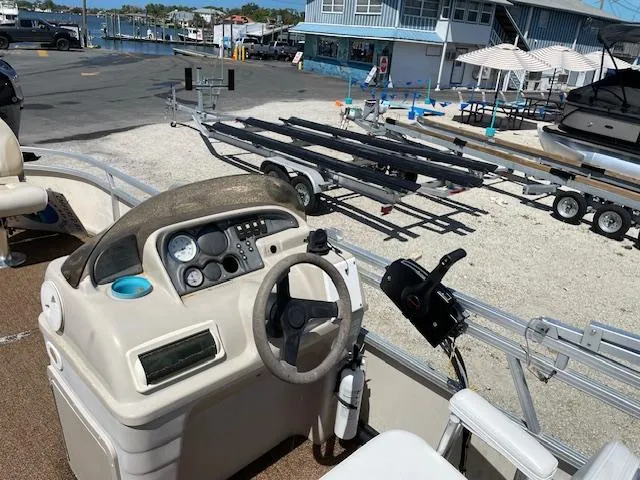 Slide: The Image of 2006 SunChaser 820 4pt Fish boat dashboard with marina background. - 1