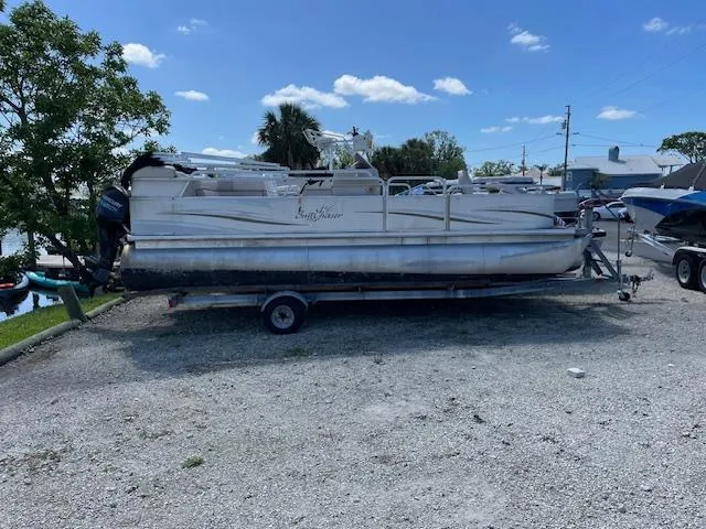 Slide: The Image of 2006 SunChaser 820 4pt Fish pontoon boat on trailer, parked outdoors. - 4