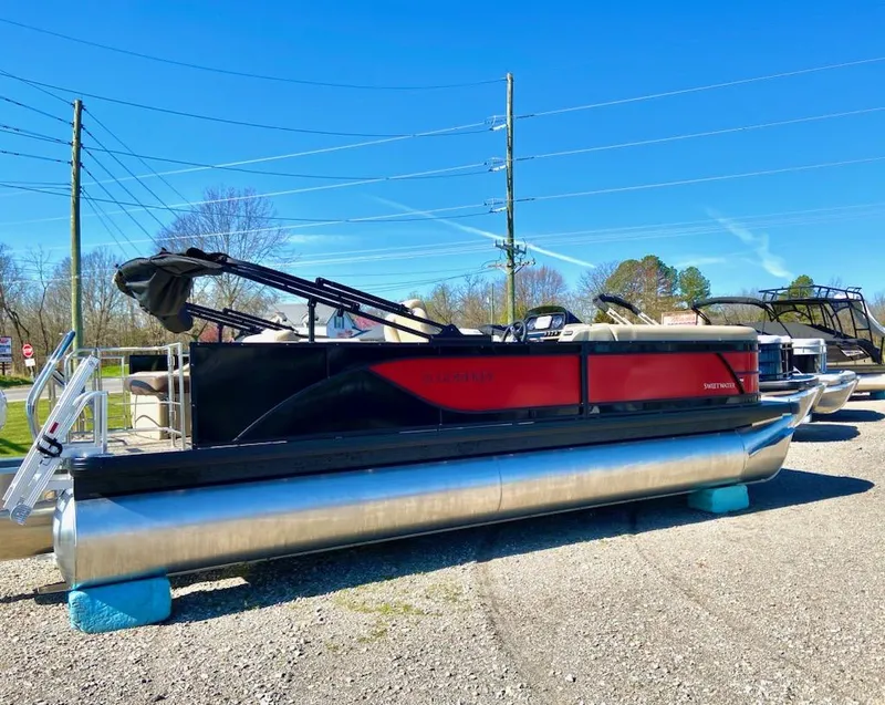 The Image of 2024 Godfrey Sweetwater SW2286SFL pontoon boat displayed outdoors on a sunny day. - 1