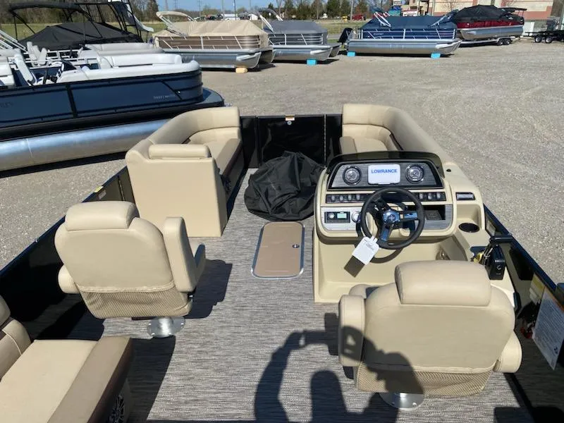Slide: The Image of 2024 Godfrey Sweetwater SW2286SFL pontoon boat interior with beige seating and control panel. - 4