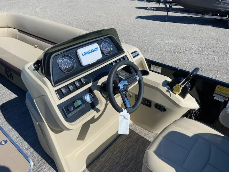 Slide: The Image of 2024 Godfrey Sweetwater SW2286SFL boat dashboard with steering wheel and Lowrance display. - 5