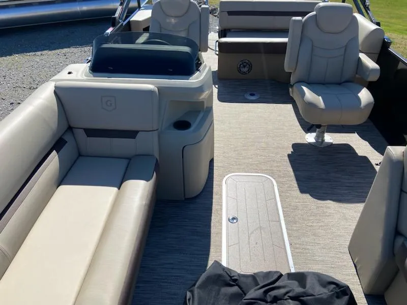 Slide: The Image of 2024 Godfrey Sweetwater SW2286SFL pontoon boat interior with beige seating and console. - 6