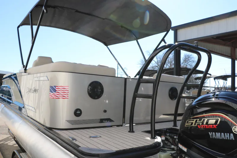 Slide: The Image of 2022 Silver Wave 2410 SW5 CLS pontoon boat with Yamaha engine and American flag decal. - 10