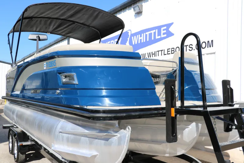 Slide: The Image of 2022 Silver Wave 2410 SW5 CLS pontoon boat with blue exterior and black canopy. - 16