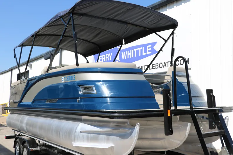 Slide: The Image of 2022 Silver Wave 2410 SW5 CLS pontoon boat with blue exterior and black canopy. - 4