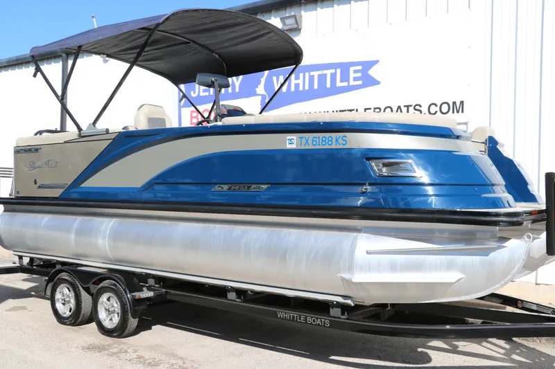 Slide: The Image of 2022 Silver Wave 2410 SW5 CLS pontoon boat with blue and silver design on a trailer. - 5