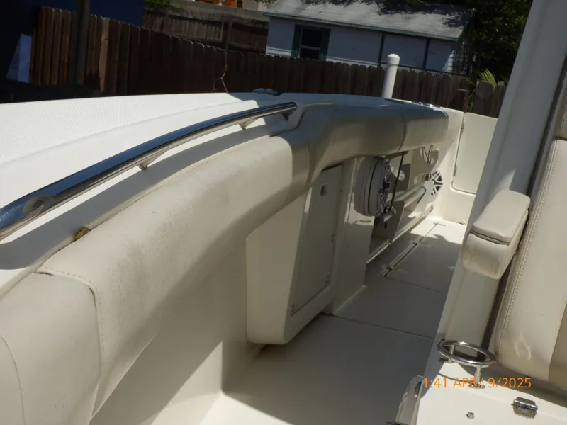 Slide: The Image of 2018 Boston Whaler 250 Outrage boat interior with cushioned seating and stainless steel railings. - 43