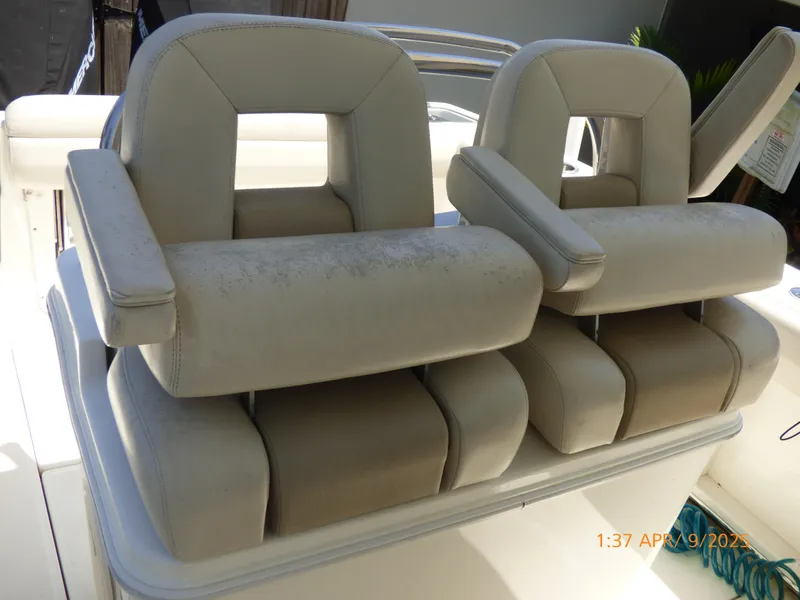 Slide: The Image of Boston Whaler 250 Outrage 2018 boat seats, beige upholstery, dual armrests, slightly worn condition. - 34