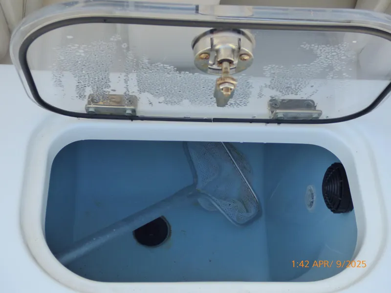 Slide: The Image of Open storage compartment on 2018 Boston Whaler 250 Outrage boat, featuring a net inside. - 45